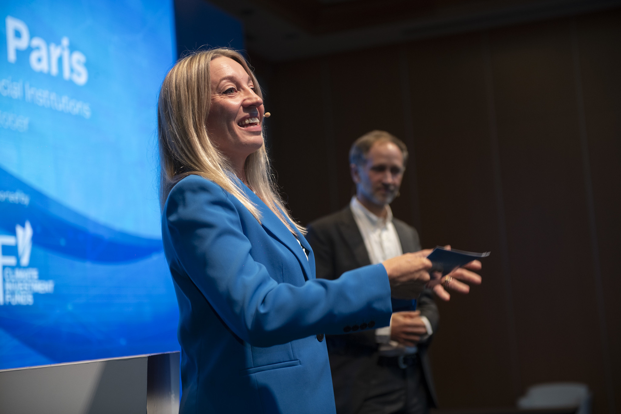 woman speaking on stage at a corporate event