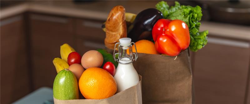 Close up shot of two paper bags with groceries